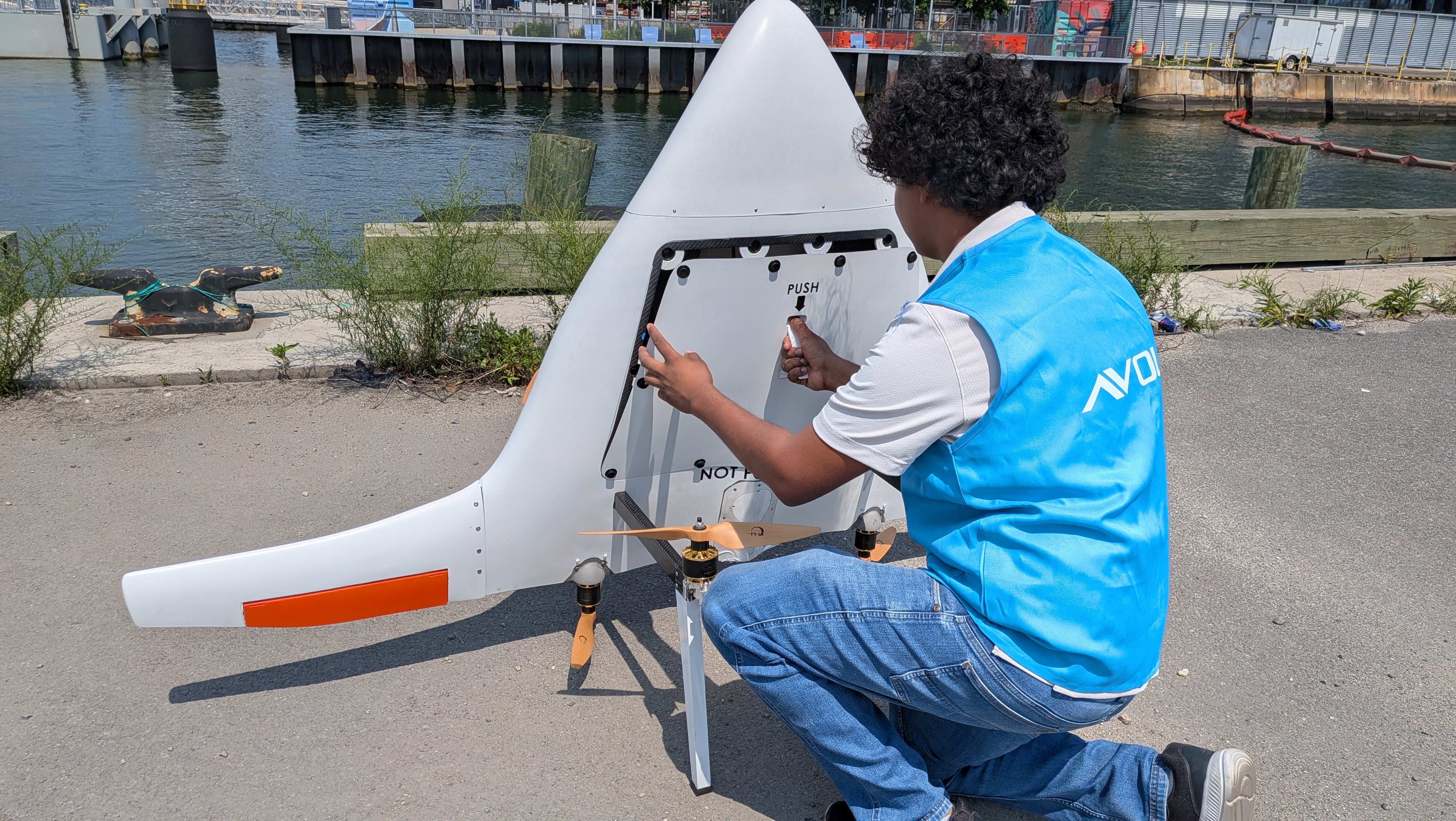 Avol operator loading a package into the delivery drone