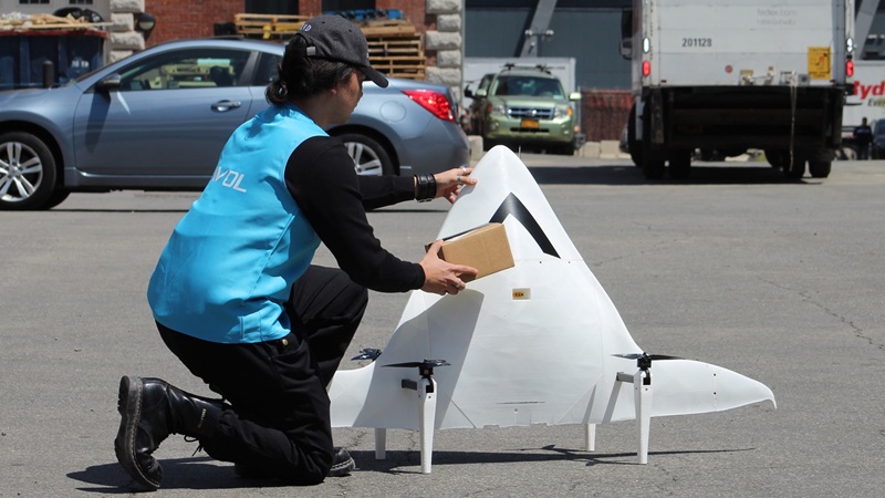An Avol operator loading a payload into the delivery drone