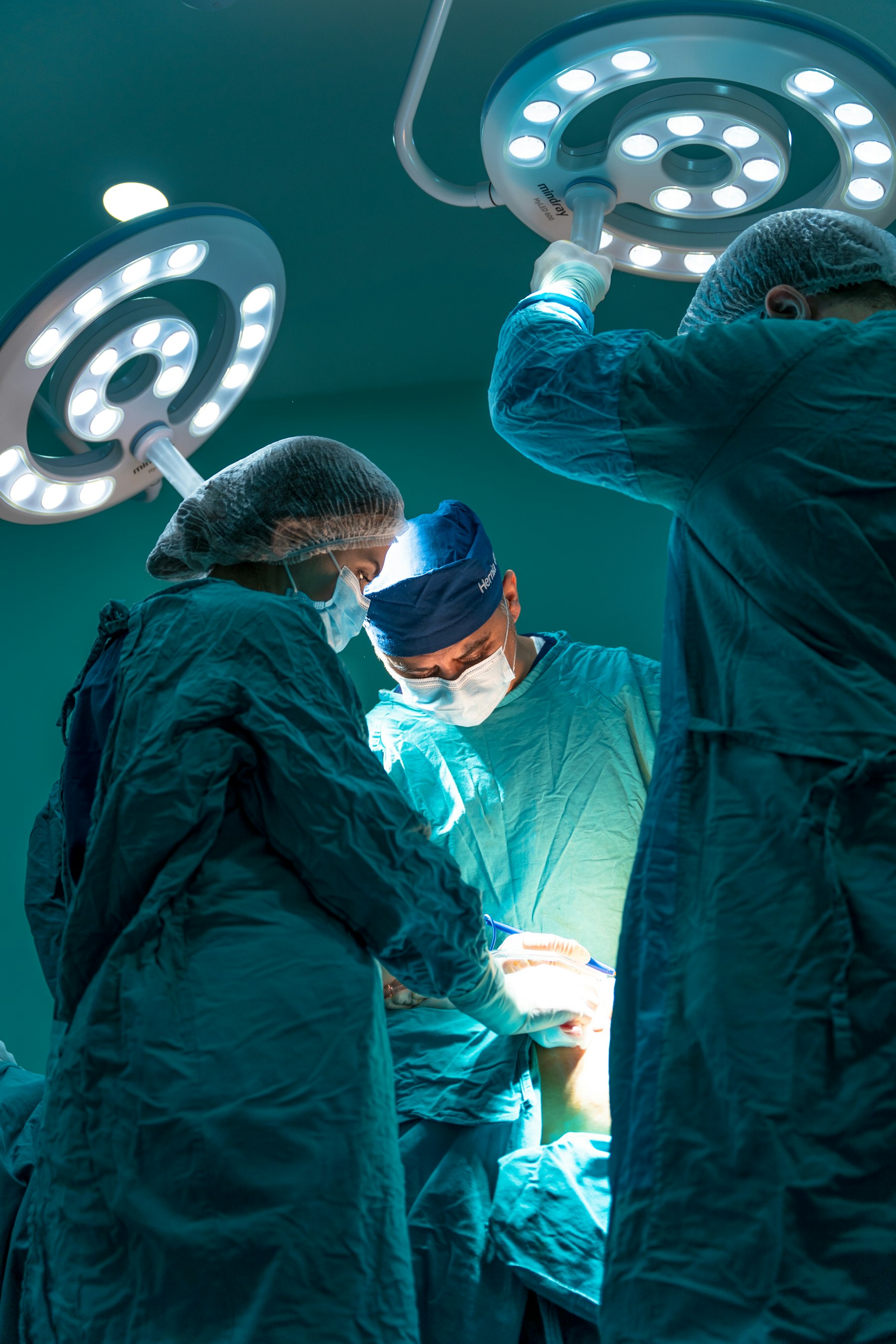 A surgical team operating under theatre lights